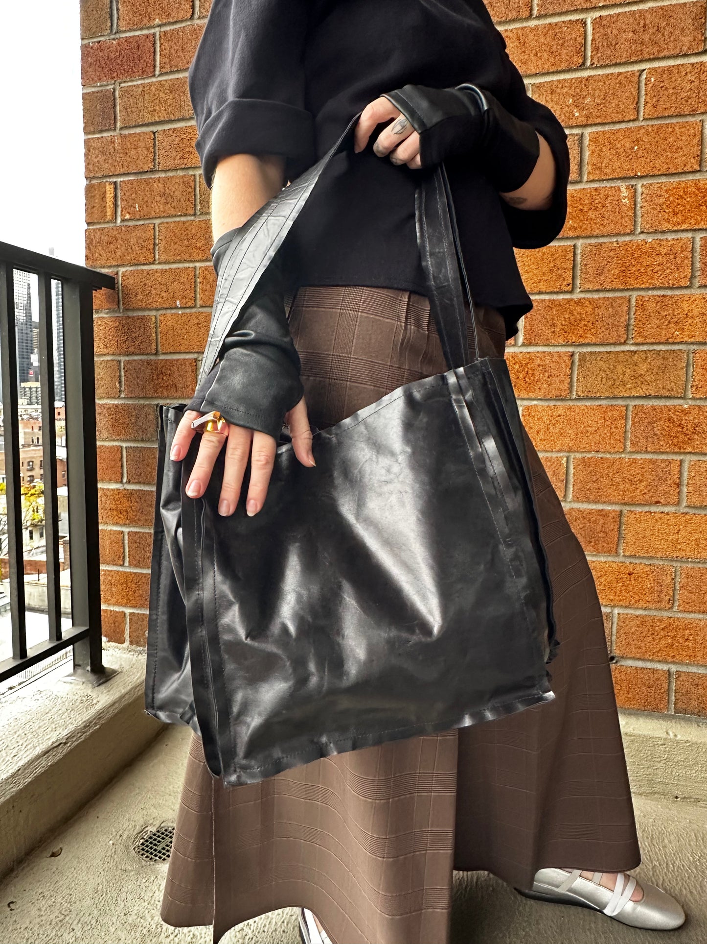An accordion leather bag with a shoulder strap