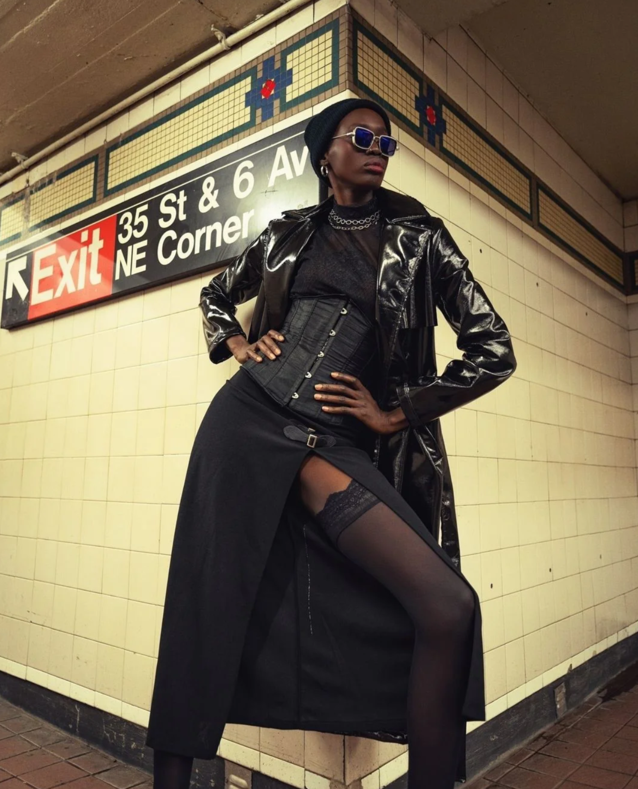 Woman wearing black lacquer leather trench coat standing in an underground subway tunnel hallway posing on the edge of a wall.
Our Ubud coat takes on the streets of NYC in these great image by @matinsdreams featuring @balangnyal