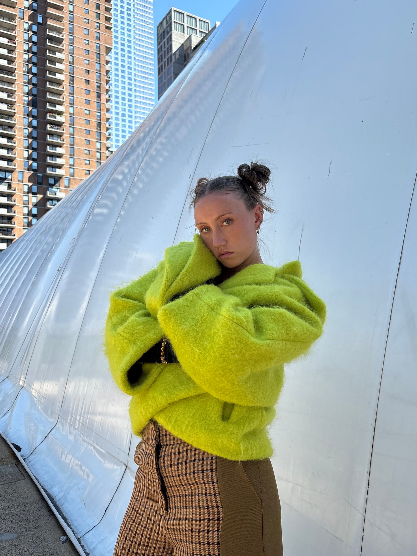 Woman posing and showing the sophisticated volume of lime coat.