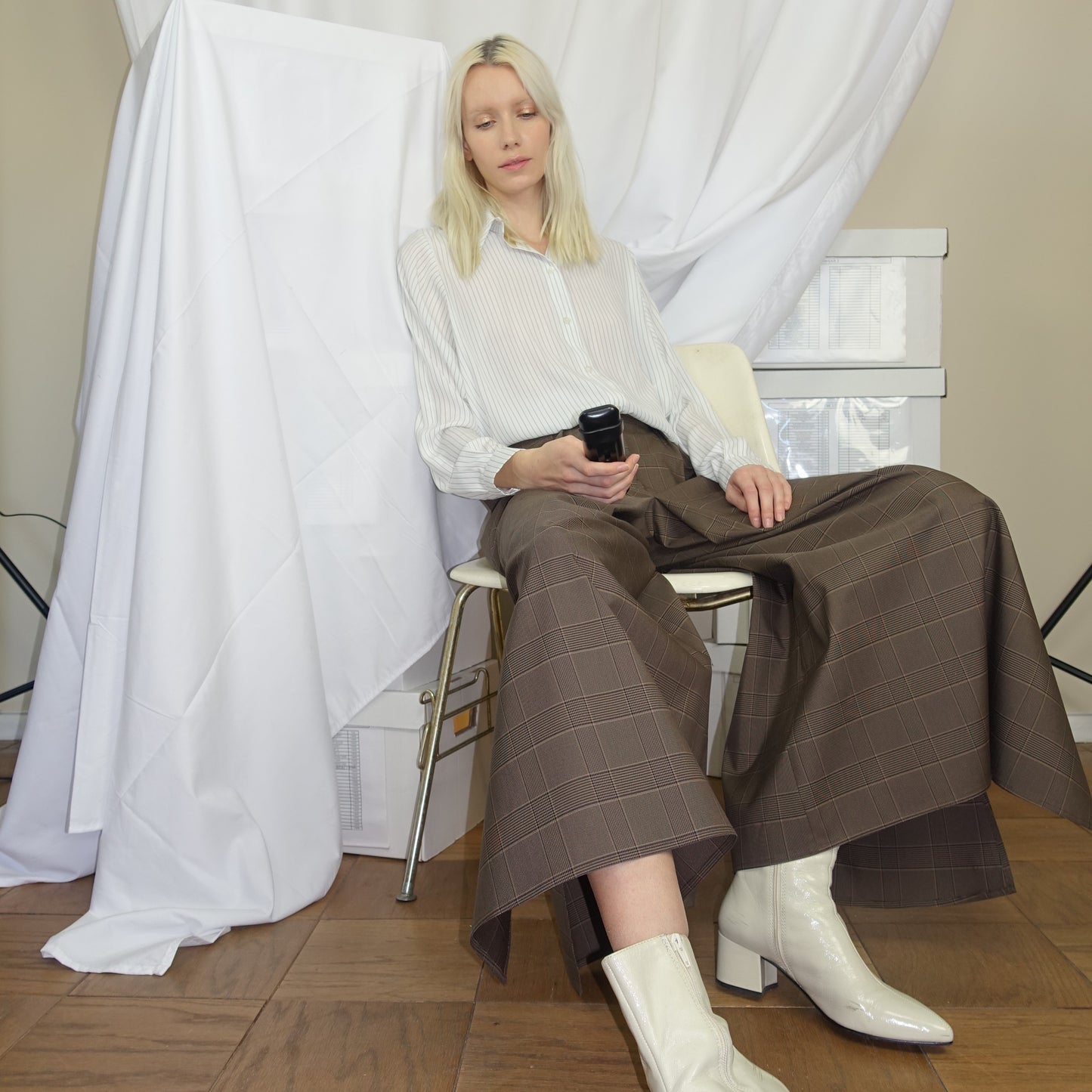Woman wearing a white and black pinstripe shirt with The Wide-Leg Culotte Sua Pant