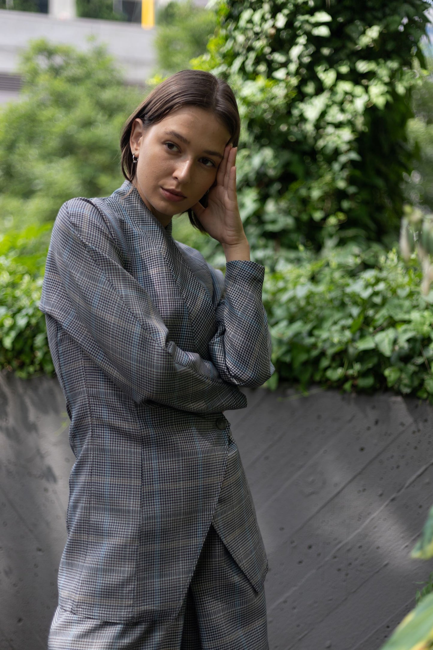 Woman pictured in double breasted wool kimono jacket and plaid wide leg pants