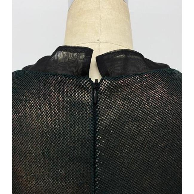 Back of black crop top cut from Italian metallic lamb suede fabric with silk organza inset details on collar and cuffs with zipper