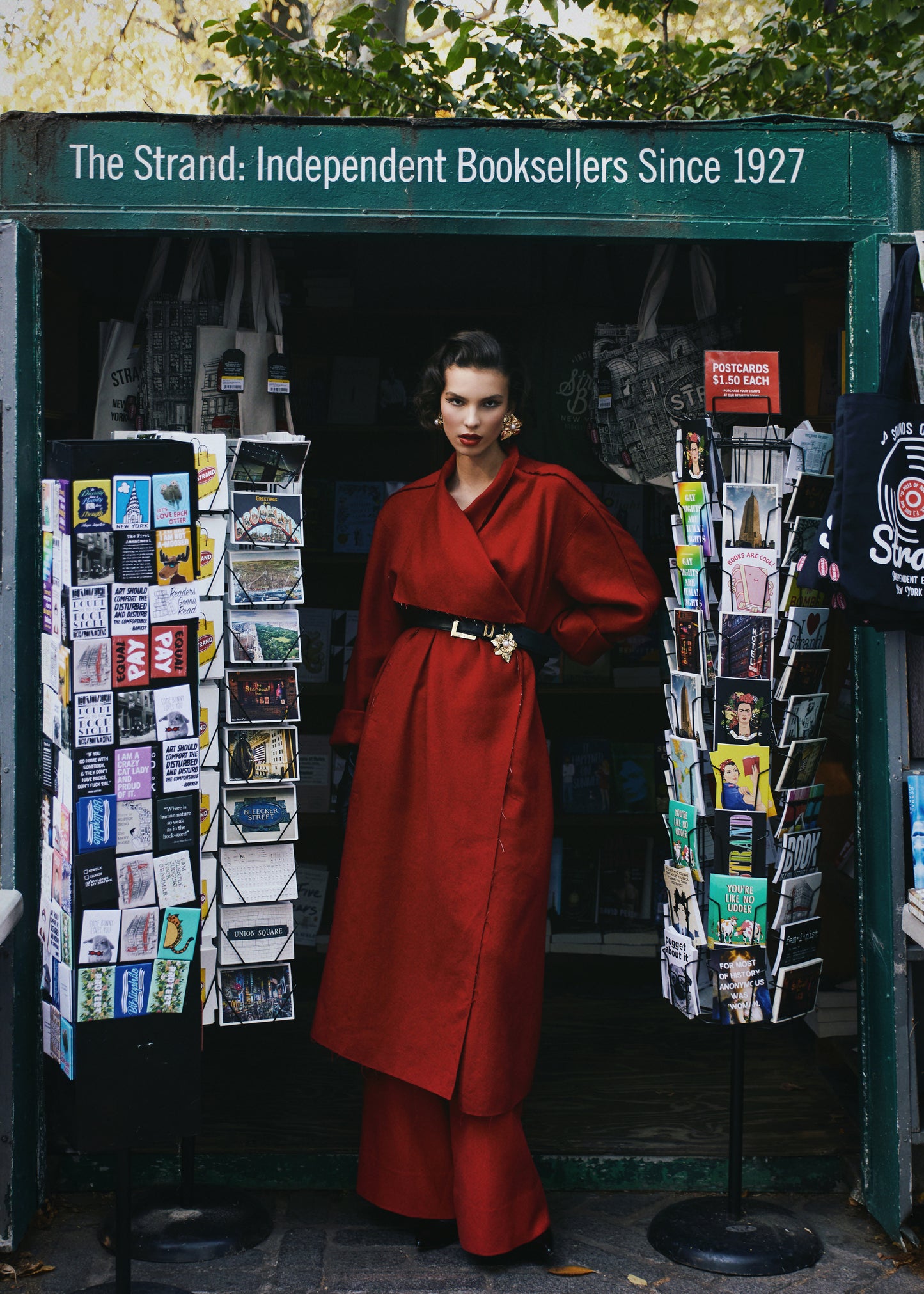 A woman wearing a red rumi coat with a black-golden accented waist belt. She is standing inside a bookstand.

By @monicabaddar
Featuring our Rumi coat
Modeled by @savka.dm
Styled by @styledbybruce
Hair by @michikoboorberg
Make up @brennadmakeup
Courtesy @the_confessional_showroom_nyc