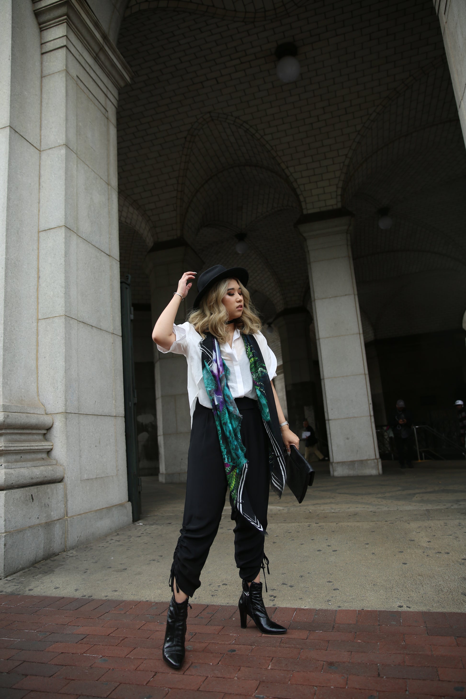 A model wearing Pants with contoured waist band and side drawstring detail in Black