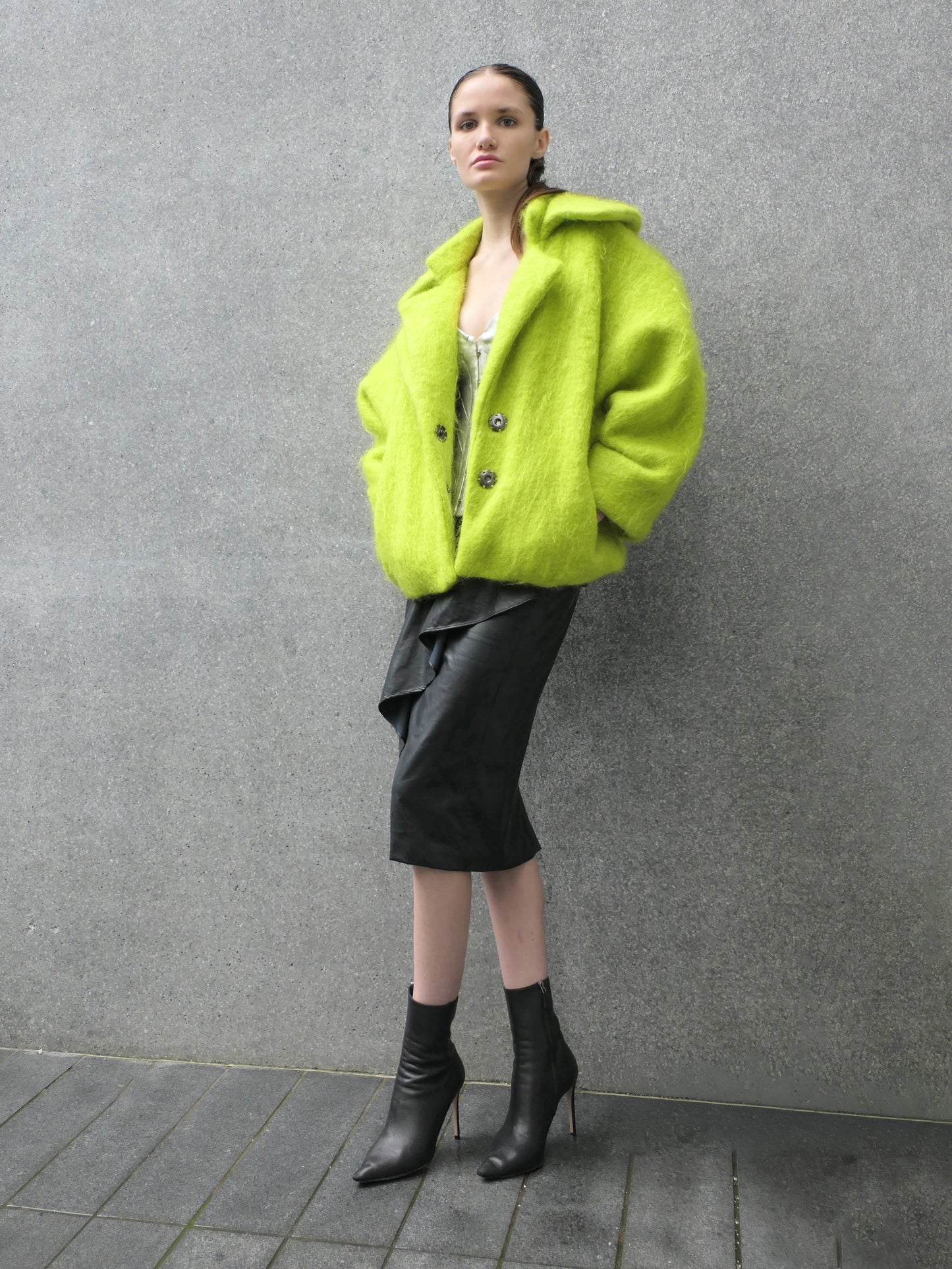 Woman standing with lime alpaca jacket, leaning on a wall.

Credits: 
Video and Styling: Nikko Kefalas @nikkokefalas
Model: Ava Easby Smith @avaeasby
Modeling and Celebrity Management: Another Level Management @anotherlevelnyc
Fashion Designer: HEIKE-NY @heike_ny