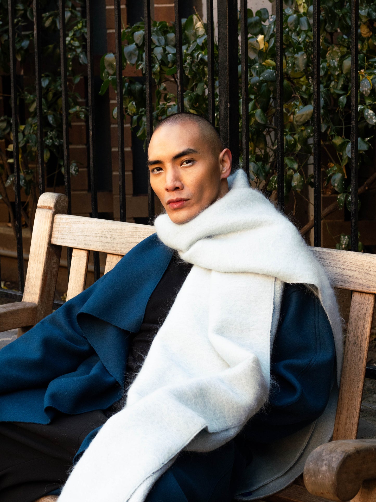 A person wearing a white scarf, acting as an outer layer for the blue rumi coat.

Model: @lejamie_