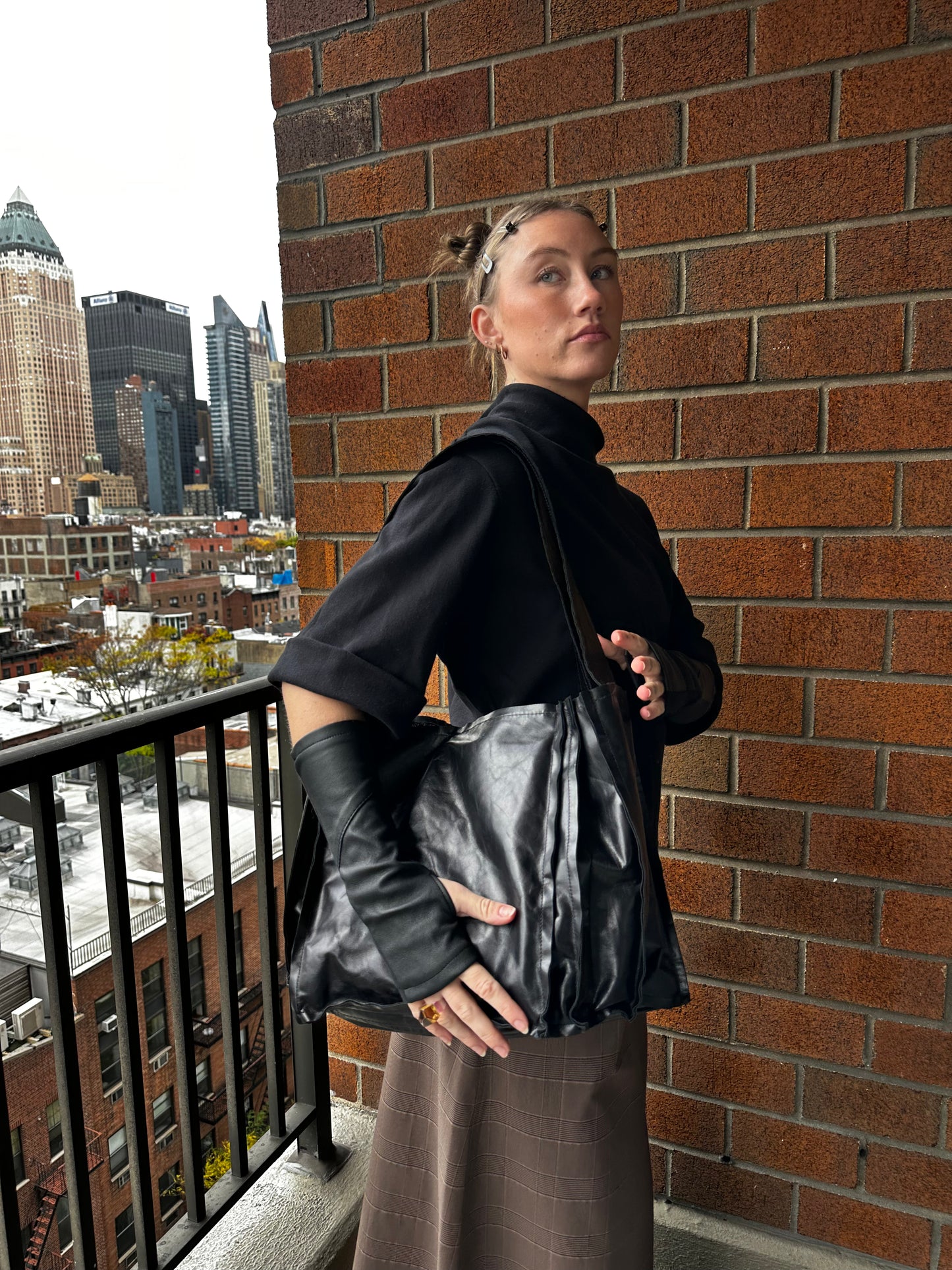 An accordion leather bag with a shoulder strap 