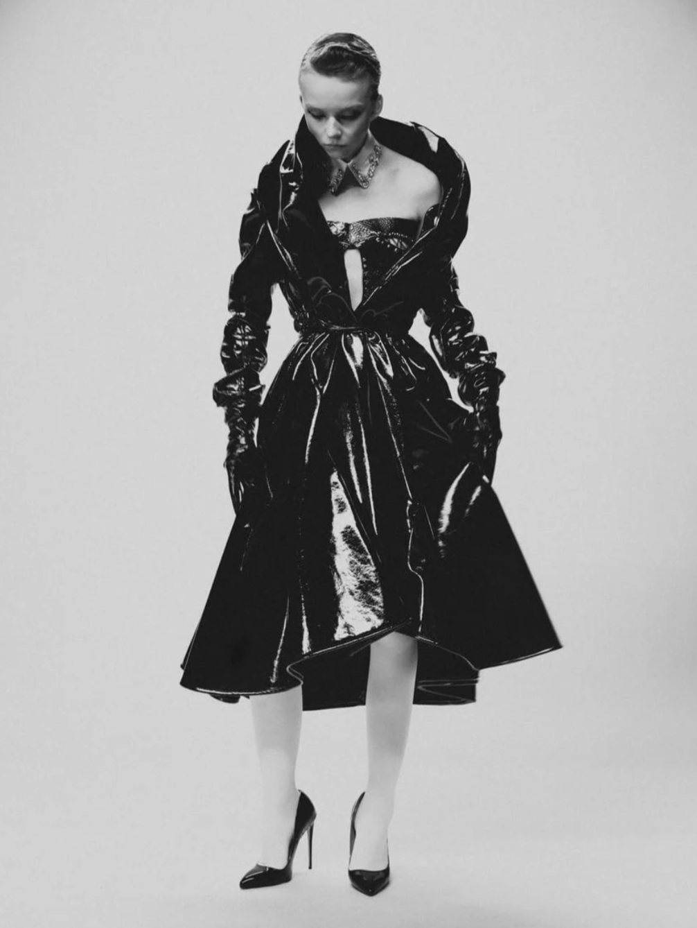 A black and white fashion portrait of a woman wearing a vegan leather patent martine coat. She is looking down.

Model @_lilynova_ in our Martine patent coat Styled by @iamyoko.j Photographed by @tommychungphotography Mua @virginialefeiy Hair @fady_mlk Courtesy of @theconfessionalshowroomnyc