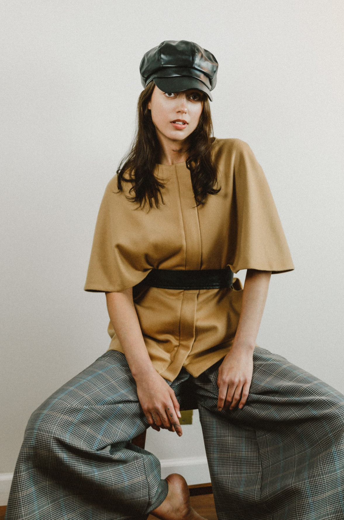 Woman wearing Cashmere cape style coat with waist belt.

Our Emerson Cape Coat styled perfectly with our plaid Sua Pants, on @aliinwonderlandd styles by @styledbynikolett and photographed by @marie_dumora