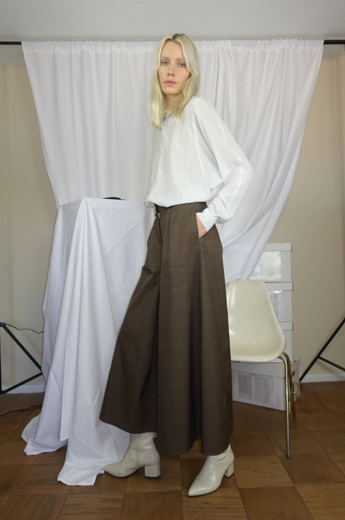 Woman wearing a white and black pinstripe shirt with The Wide-Leg Culotte Sua Pant