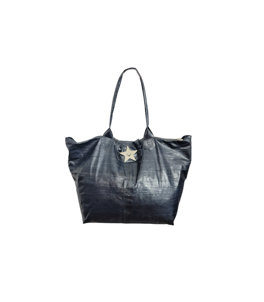 A blue eelskin leather tote bag with a prominent silver star-shaped hardware accent on the front