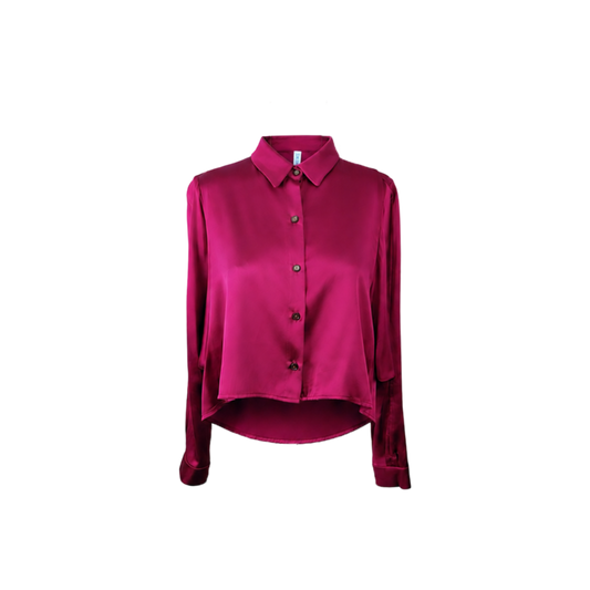 A long-sleeve satin blouse in a rich fuchsia color, featuring a classic pointed collar, button-down front, and a distinctive asymmetrical draped hem