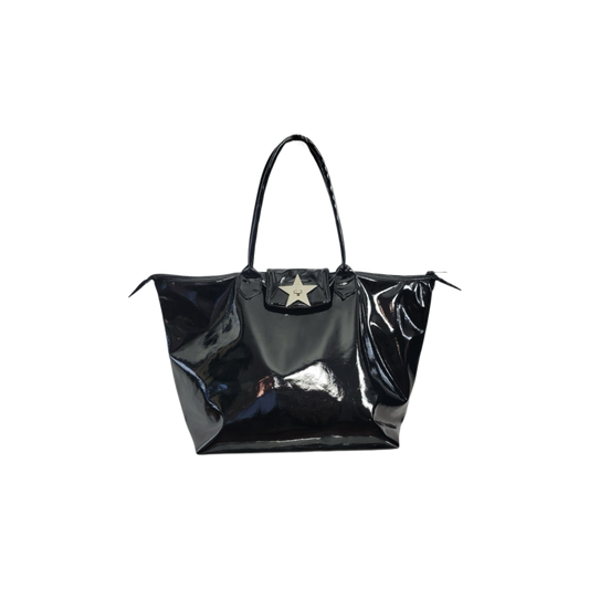A shiny black patent leather tote bag with a central silver star emblem