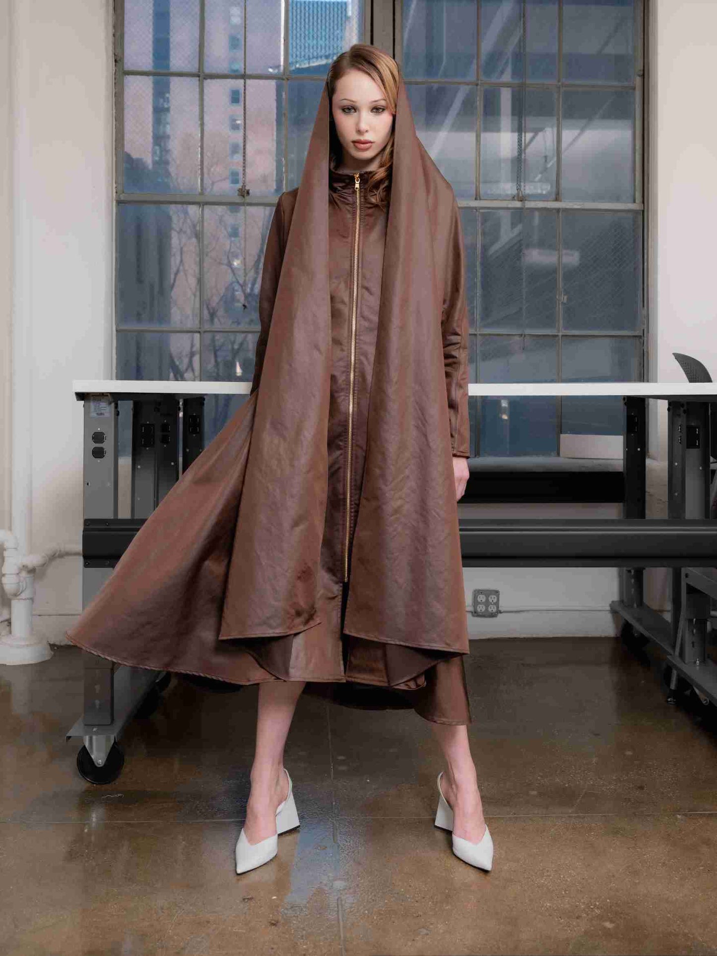 Woman wearing a chocolate satin martine coat standing straight and posing in front of a window.

@natalieturnerr captured beautifully by @_vazhak_ creative eye @kent.nycfashion
@makohairmakenyc
@gabriel.barse
@suecandia
@the_confessional_showroom_ny
@confessional_showroom_miami